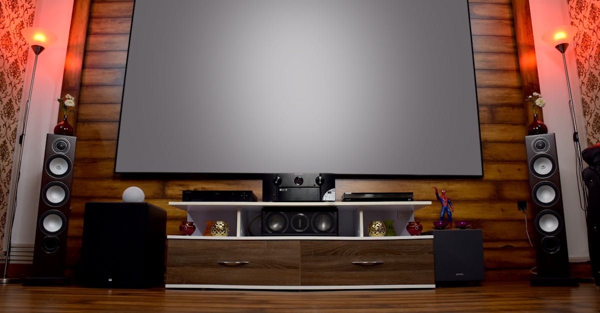 Stylish home theater featuring large screen, audio system, and decor, perfect for entertainment.