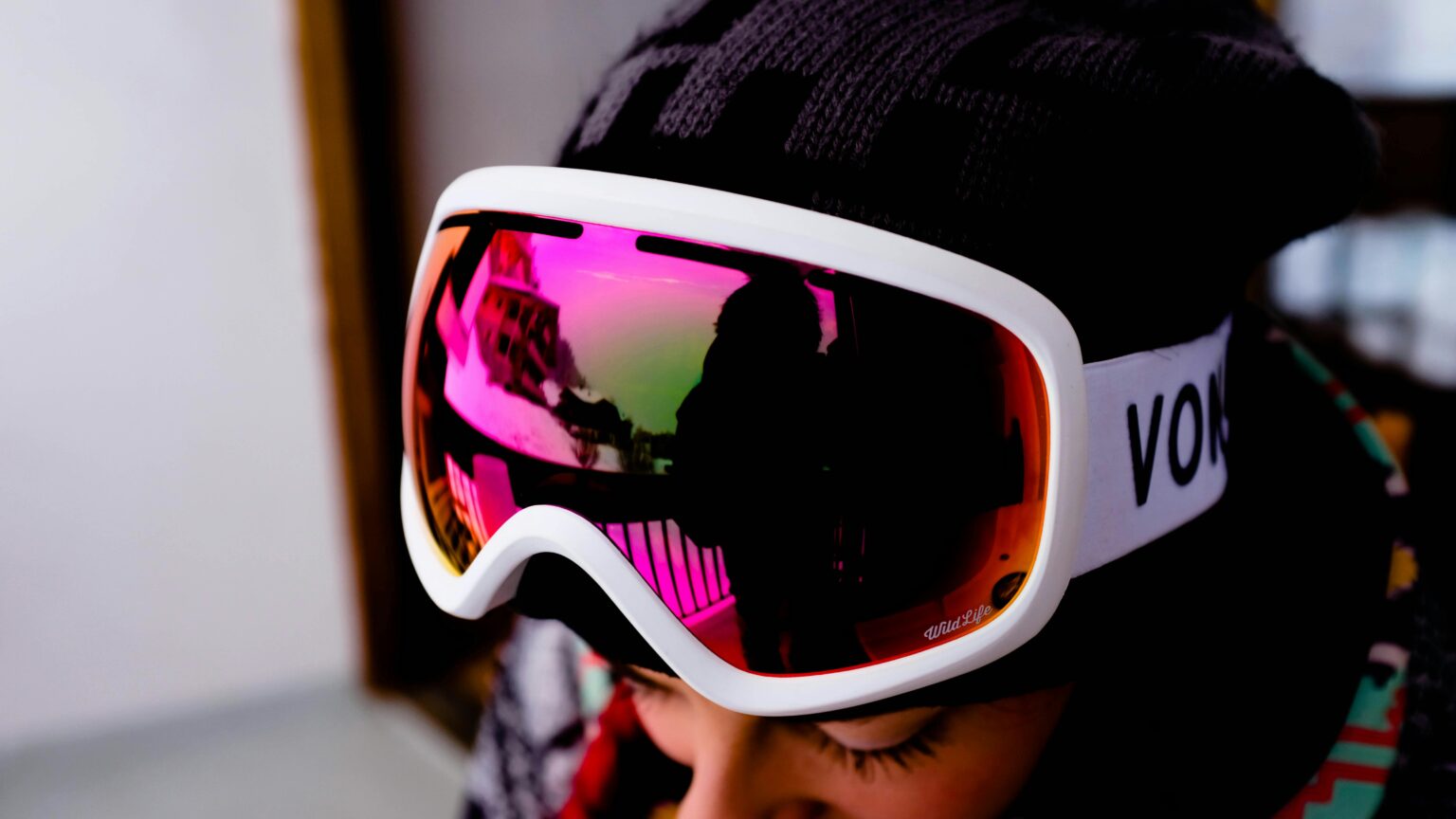 Vibrant reflection in winter snowboarding goggles, showcasing a snowy landscape.