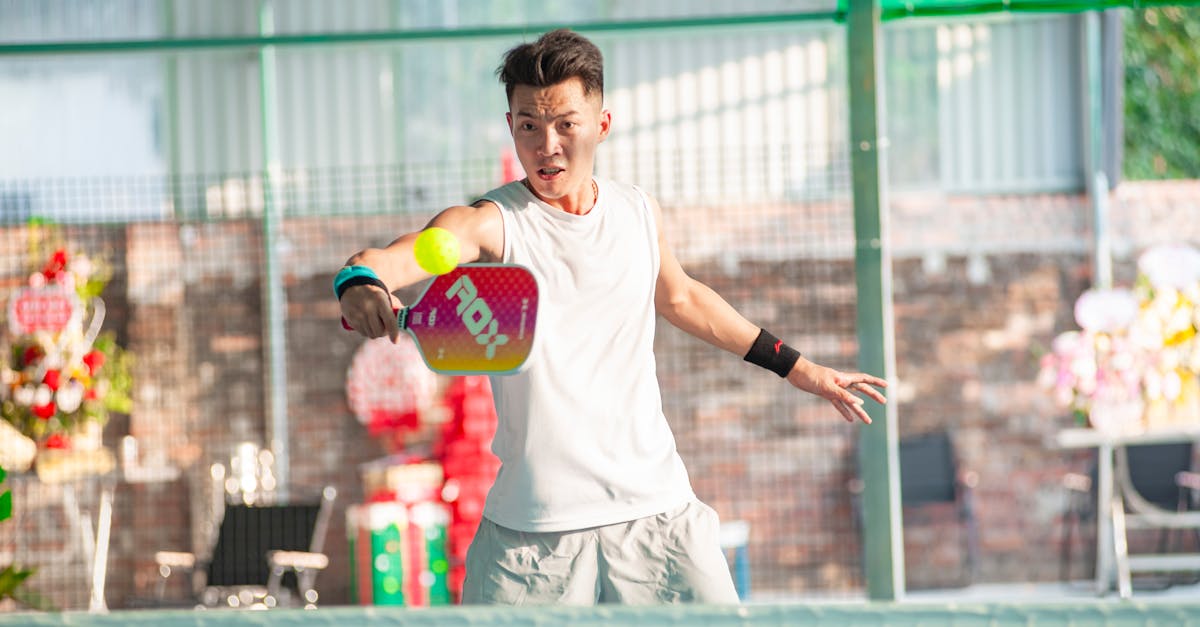 Dynamic shot of a young man playing pickleball indoors in Hanoi, Vietnam.