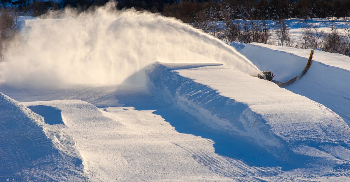 Snow blower shaping a ski halfpipe in Geilo, Norway. Winter landscape at a ski resort.